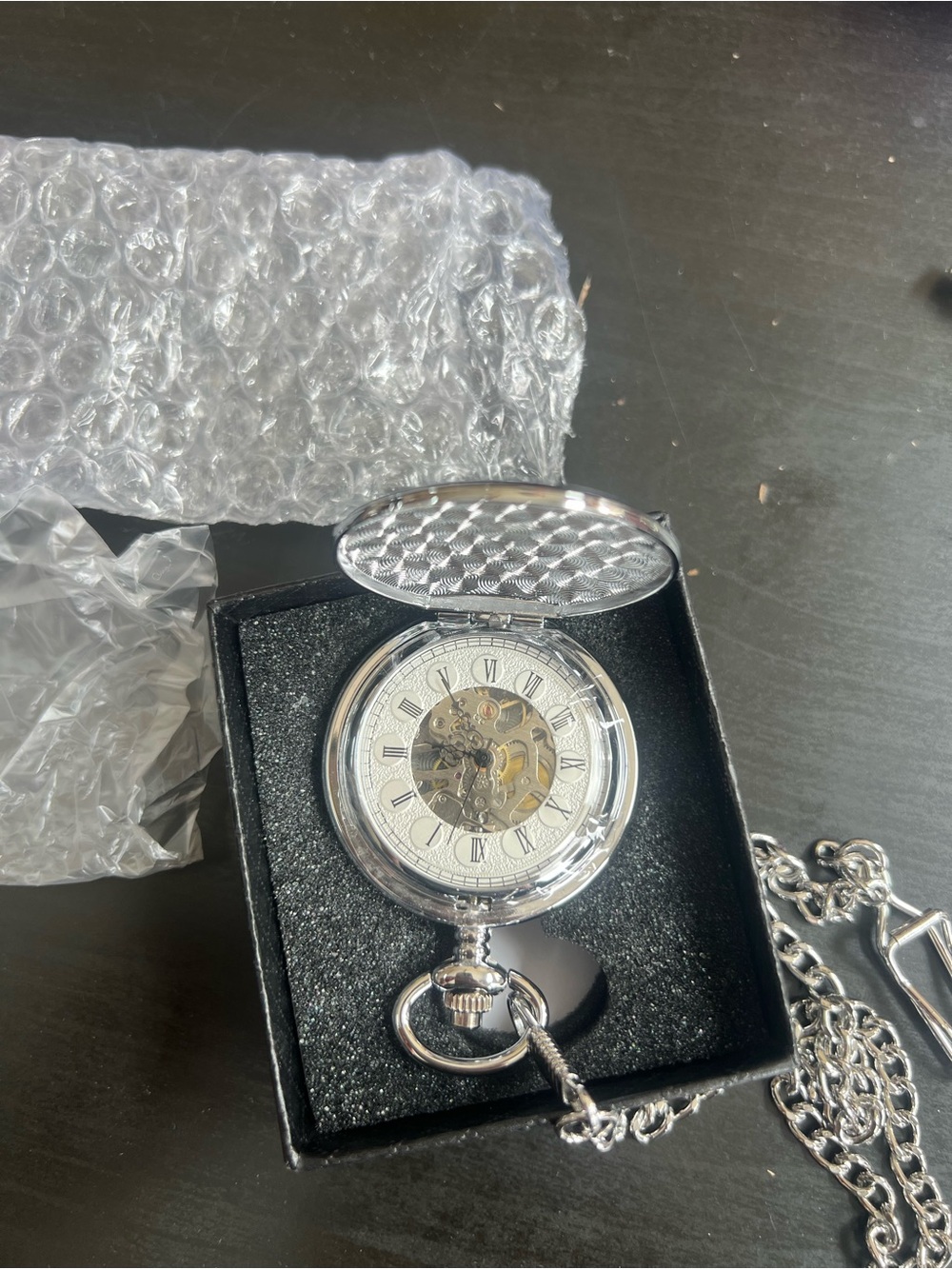 silver-tone mechanical skeleton pocket watch featuring an exposed gear movement